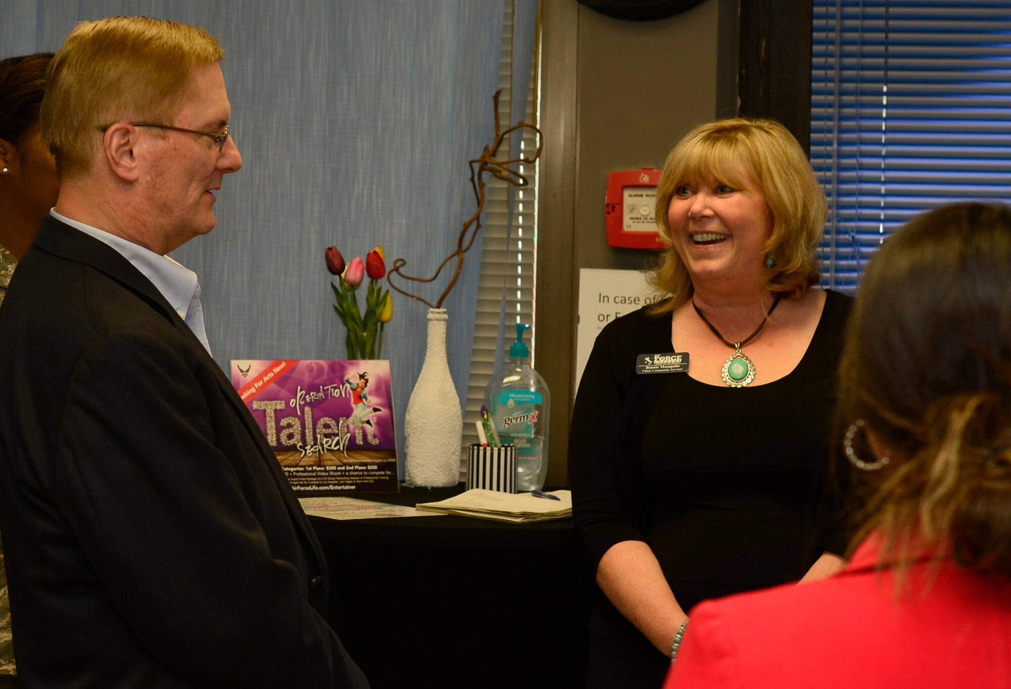 Frank Beatty, spouse of Secretary of the Air Force Deborah Lee James, speaks with Bonnie Masapollo, community services chief, during a visit, April 30, 2015, at Aviano Air Base, Italy.  During her visit, James thanked civilians for their contributions to the Air Force mission. (U.S. Air Force photo by Airman 1st Class Cary Smith/Released)