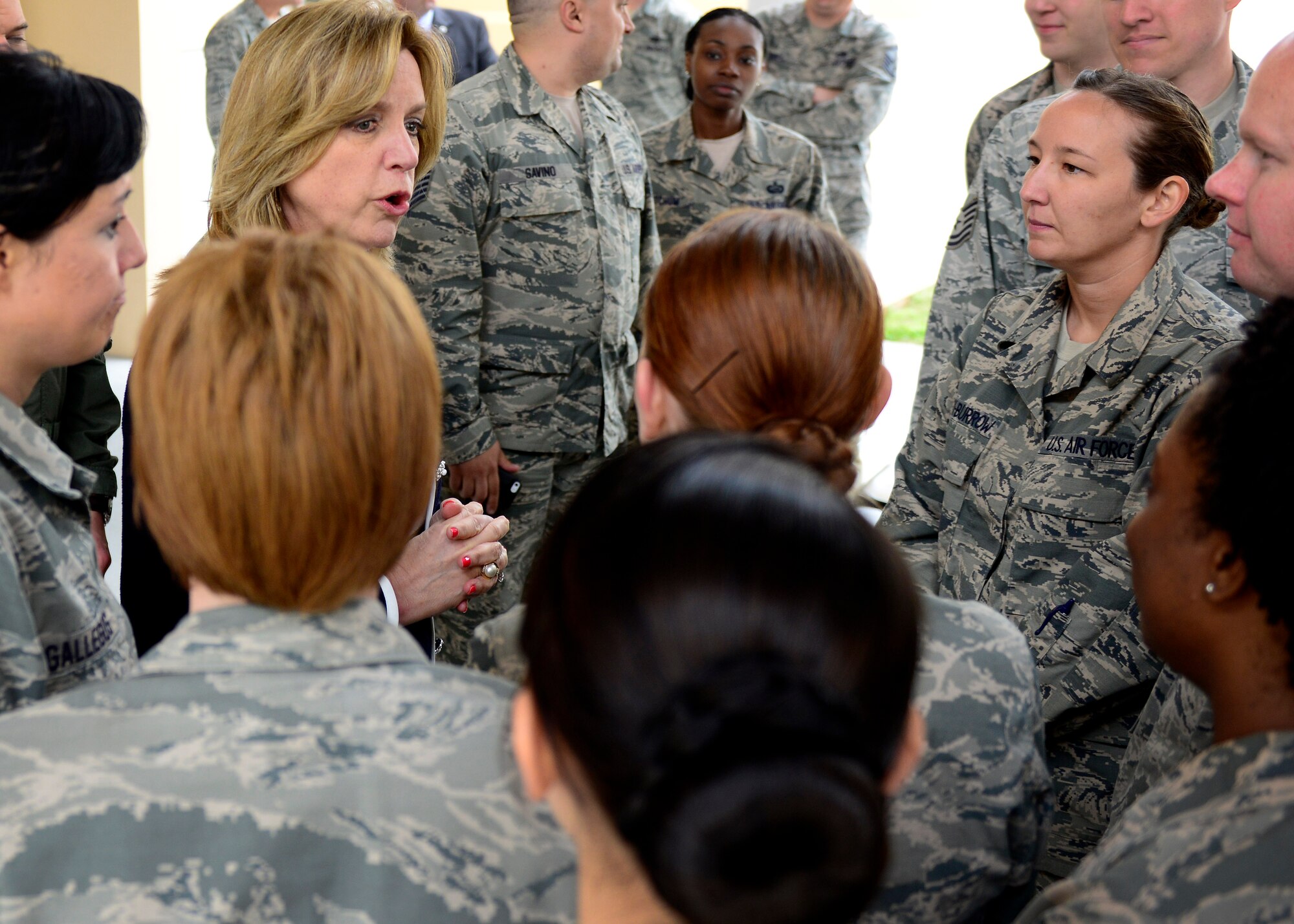 Frank Beatty, spouse of Secretary of the Air Force Deborah Lee James, speaks with Bonnie Masapollo, community services chief, during a visit, April 30, 2015, at Aviano Air Base, Italy.  During her visit, James thanked civilians for their contributions to the Air Force mission. (U.S. Air Force photo by Airman 1st Class Cary Smith/Released) 