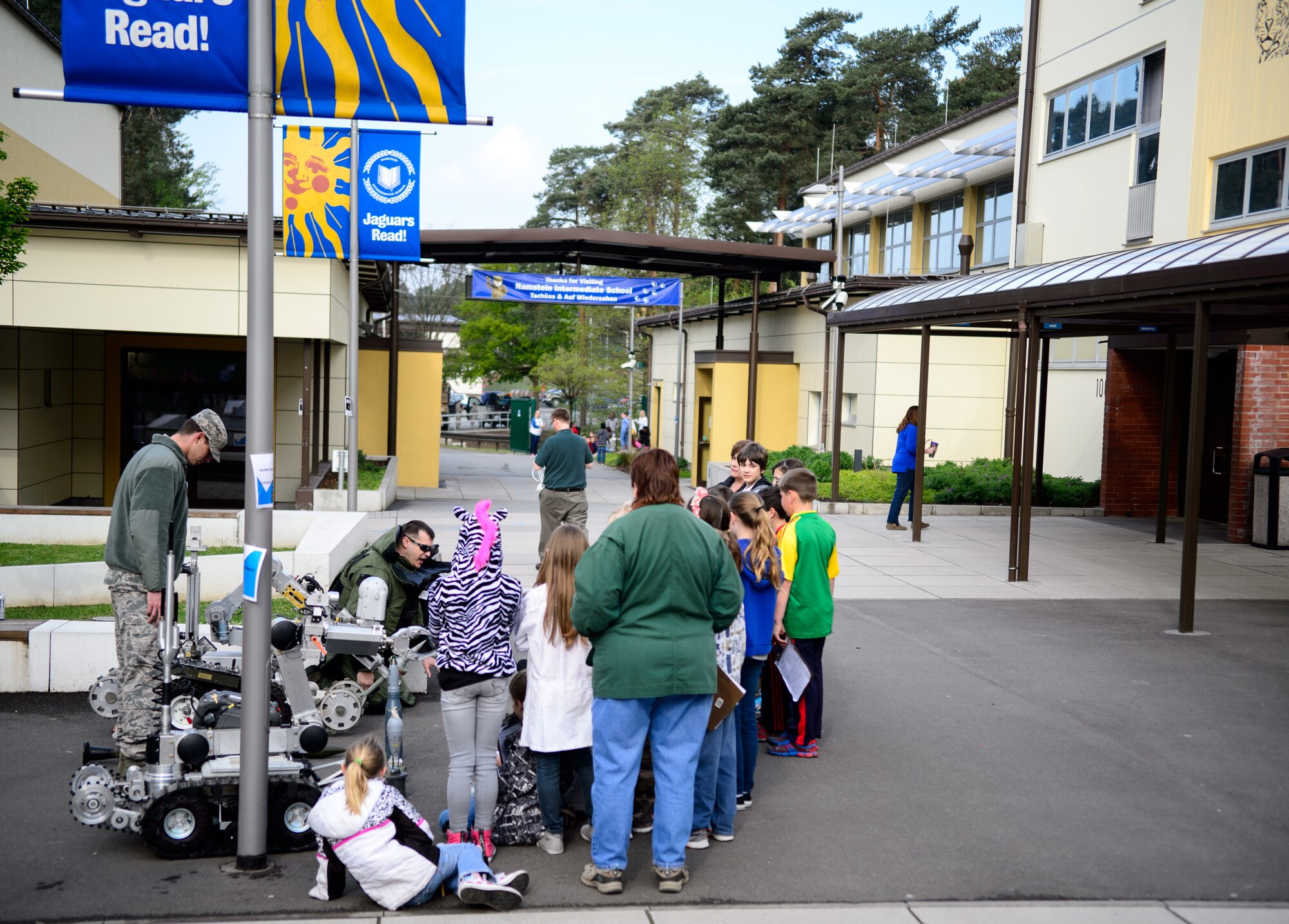 Explosive Ordnance Disposal Airmen teach children about their career April 28, 2015, at Ramstein Intermediate School Ramstein Air Base, Germany. The school hosted a career day to educate children on a variety of jobs performed daily around Ramstein. (U.S. Air Force photo/Staff Sgt. Armando A. Schwier-Morales)