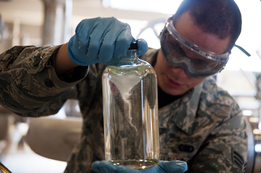 U.S. Air Force Senior Airman Brett Carter, 35th Logistics Readiness Squadron fuels laboratory technician, creates a vortex in a fuel sample to identify any visual sediment at Misawa Air Base, Japan, May 1, 2015. Fuel delivered by pipeline to Misawa  from Hachinohe, Japan, is inspected every morning to ensure clean and contaminate free product.  (U.S. Air Force photo by Senior Airman Jose L. Hernandez-Domitilo/Released)