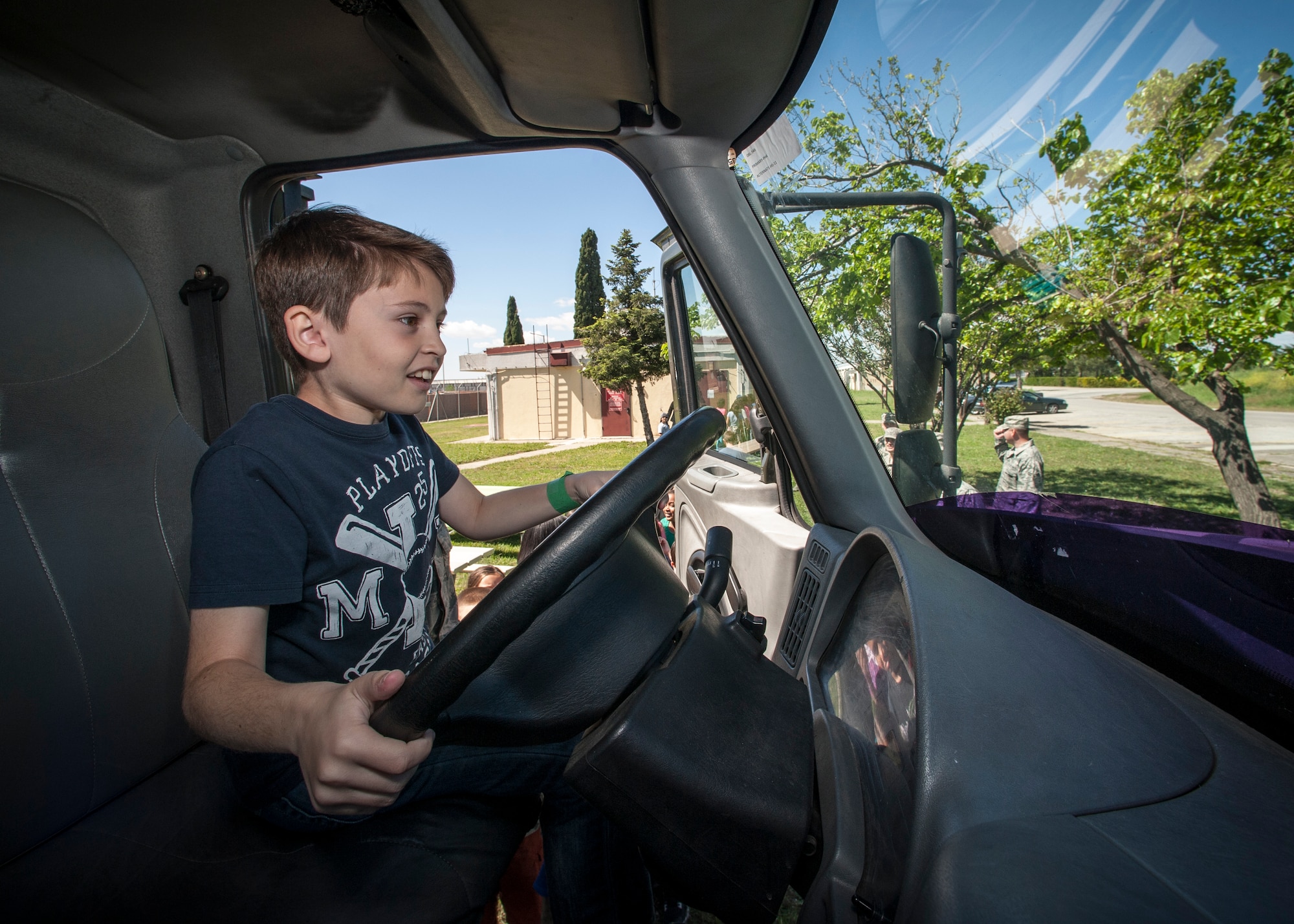 Mert, 39th Air Base Wing dependent, sits in the driver’s seat and honks the horn of a 39th Logistics Readiness Squadron fuels truck during the 2015 Job Shadow Day April 24, 2015, at Incirlik AB, Turkey. After the dependents visited base squadrons they congregated at the base track for lunch and interactive base squadron stations. (U.S. Air Force photo by Airman 1st Class Cory W. Bush/Released)