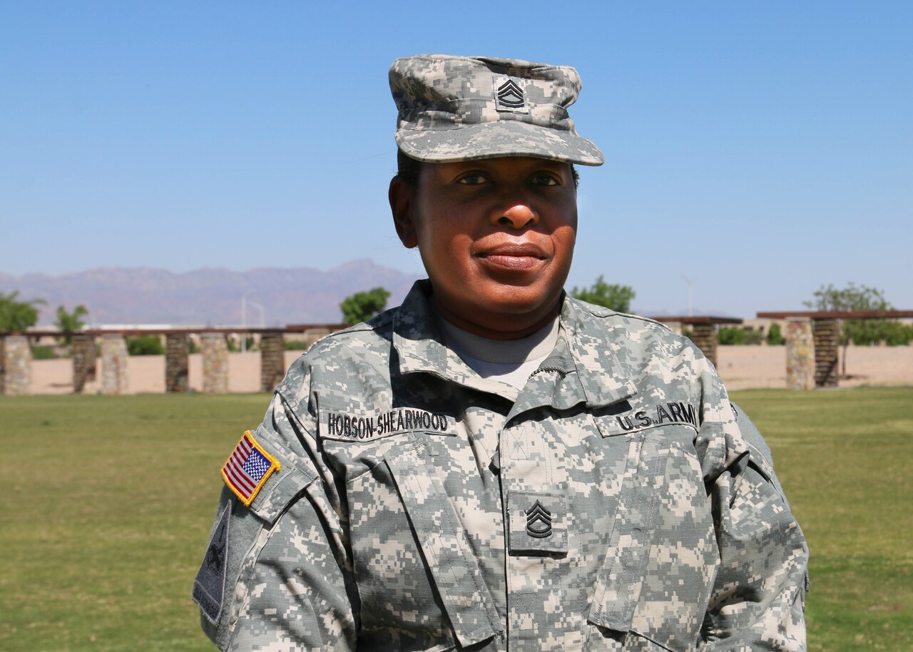 Army Sgt. 1st Class Lynnette Hobson-Shearwood, who recently saved the life of a drowning child in a swimming pool, poses outside a headquarters building on Fort Bliss, Texas, April 29, 2015. U.S. Army photo by Staff Sgt. Kristen Duus