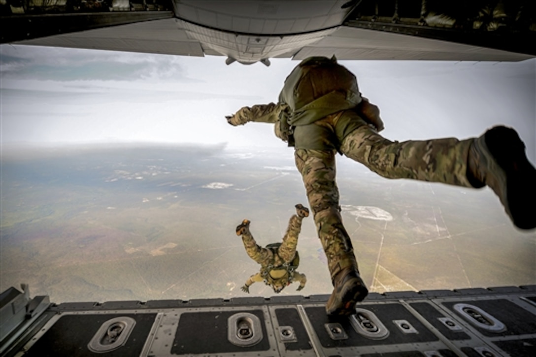 Army Green Berets jump from a C-130H3 Hercules aircraft during Emerald Warrior on Hurlburt Field, Fla., April 22, 2015. 