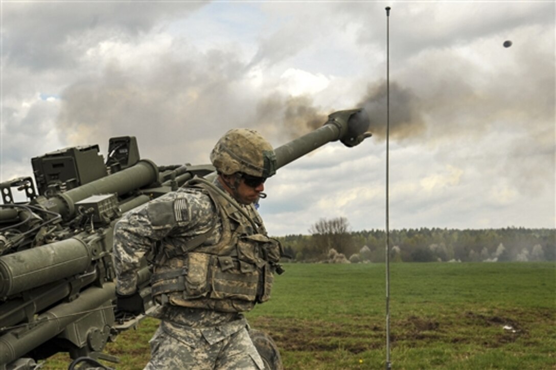 U.S. Army Spc. Leandro Gomez fires an M777A2 howitzer during a live-fire exercise on the Grafenwoehr Training Area in Germany, April 30, 2015. Gomez is a paratrooper assigned to 4th Battalion, 319th Airborne Field Artillery Regiment, 173rd Airborne Brigade.