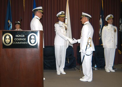 U.S. Navy Adm. Cecil D. Haney (center), U.S. Strategic Command commander, congratulates U.S. Navy Capt. Andrew Feinberg (center right), incoming Joint Warfare Analysis Center commander, during a change of command ceremony, Dahlgren, Va., May 1, 2015. During the ceremony, U.S. Navy Capt. R. Chandler Swallow (center left) relinquished command and retired from military service after serving as JWAC commander. Feinberg assumed command of the USSTRATCOM functional component that analyzes information provided by the intelligence community and recommends solutions to some of the most complex challenges faced by combatant commands, the Joint Staff, and civilian agencies. USSTRATCOM is one of nine DoD unified combatant commands and is charged with strategic deterrence; space operations; cyberspace operations; joint electronic warfare; global strike; mission defense; intelligence, surveillance and reconnaissance; combat weapons of mass destruction; and analysis and targeting. (Photo courtesy of Steven Moore, JWAC PAO)