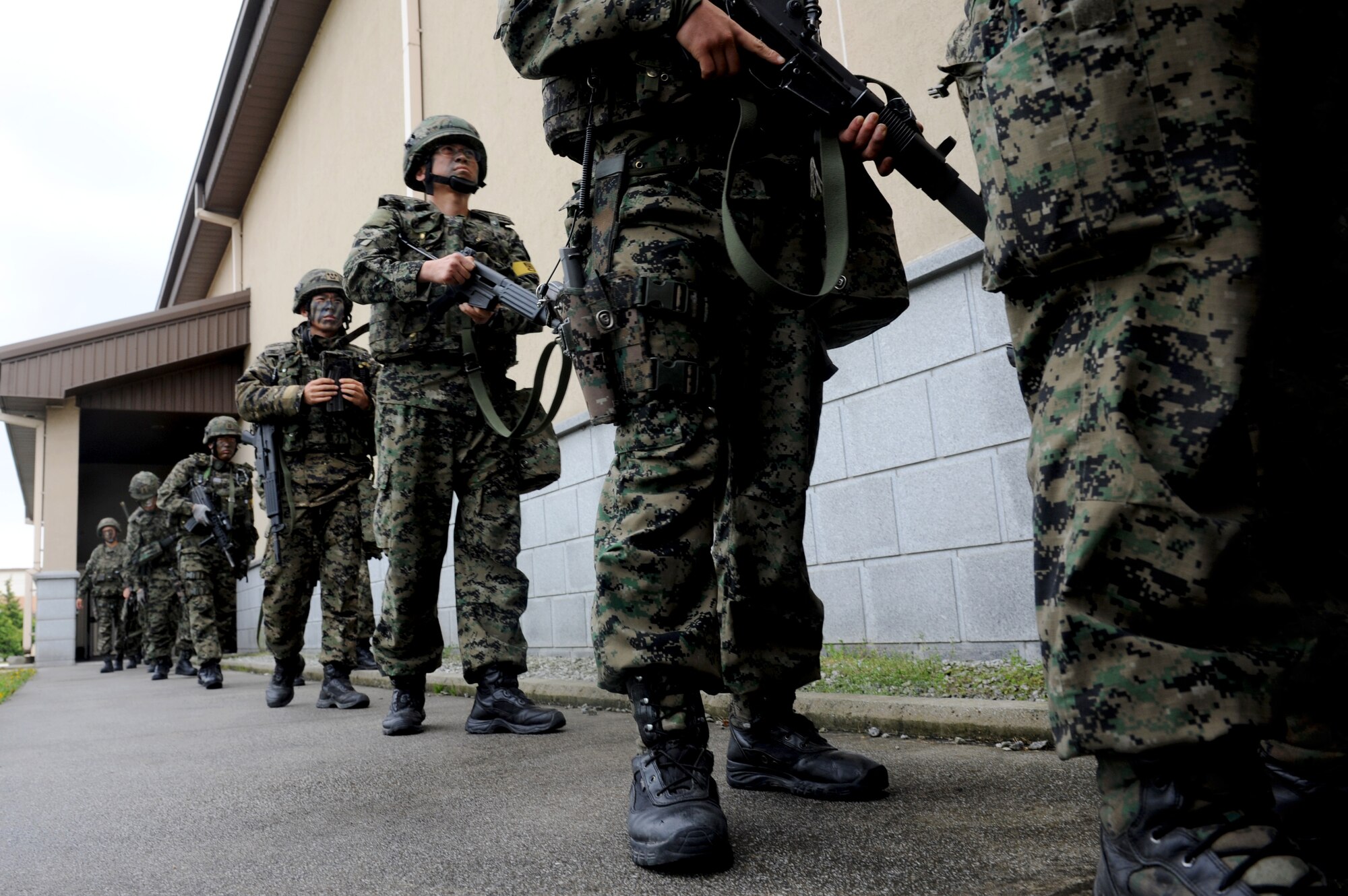 Members from the Republic of Korea Special Operations Forces 35th Battalion, 7th Airborne Brigade, wait in line to clear their weapons before starting combined defense training April 29, 2015, at Kunsan Air Base, Republic of Korea. For the first time in more than seven years, ROKSOF integrated operations with Wolf Pack defenders during a 24-hour exercise held in conjunction with Exercise Beverly Midnight 15-3. (U.S. Air Force photo by Senior Airman Divine Cox/Released)