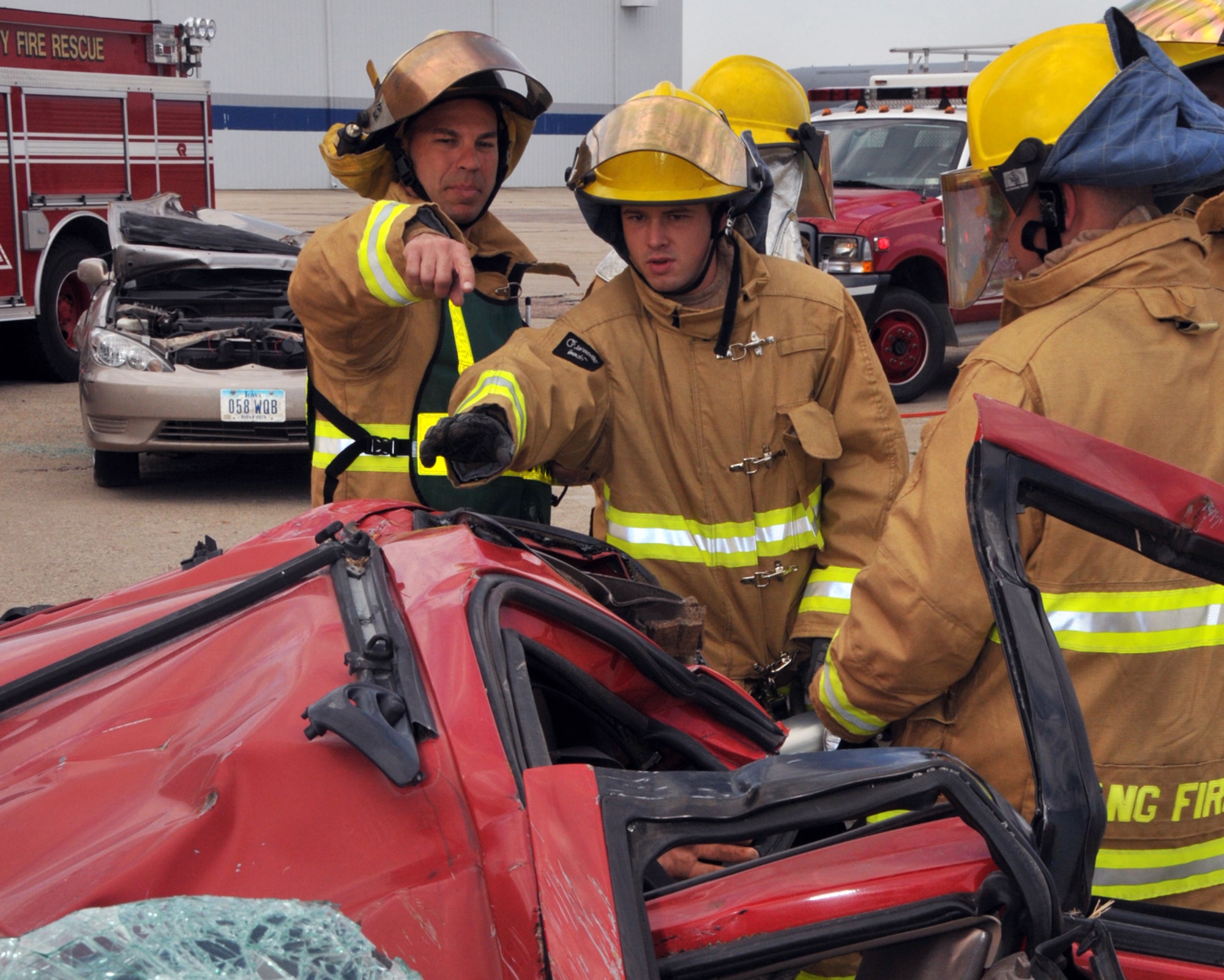 Members of the 185th Air Refueling Wing Fire Protection Services Flight, along with other local fire and rescue groups, practice using the tools and techniques to extract victims from vehicles during a mass casualty exercise at the Sioux Gateway Airport/Col. Bud Day Field in Sioux City, Iowa on Saturday May 2, 2015.  (U.S. Air National Guard photo by Tech. Sgt. Bill Wiseman/Released) 