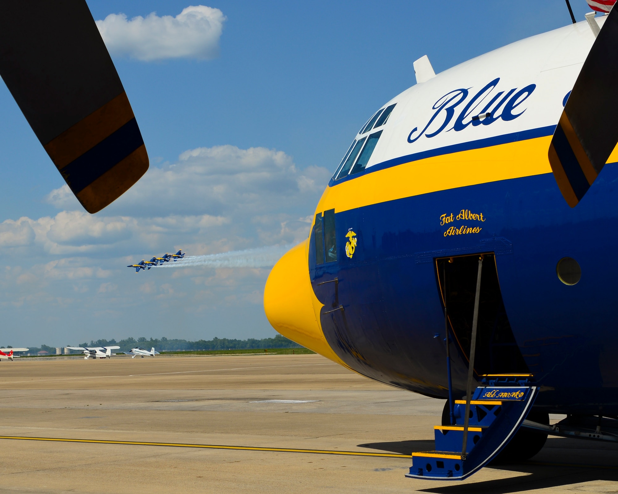 The U.S. Navy Flight Demonstration Team Blue Angels F/A-18 Hornets make a pass behind their C-130 Hercules, Fat Albert, during the 2015 Defenders of Liberty Air Show at Barksdale Air Force Base, Louisiana, May 1. The Blue Angels are the headlining act of the 2015 Defenders of Liberty Air Show. (U.S. Air Force photo/Senior Airman Benjamin Raughton)