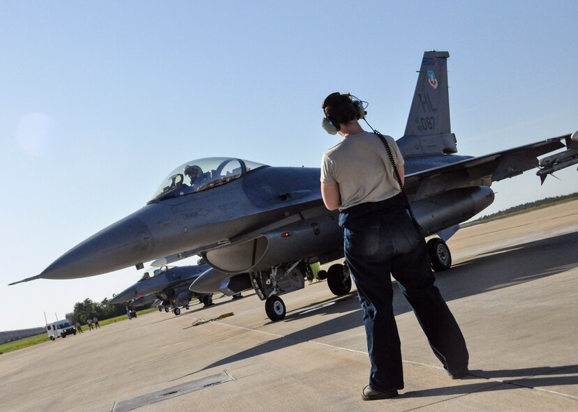 Staff Sgt. Heather Halti, 419th Aircraft Maintenance Squadron crew chief, clears 1st Lt. Sean Rush, an active-duty F-16 pilot with the 388th Fighter Wing, for takeoff during the Emerald Warrior Exercise at Eglin AFB Fla. Nearly 300 personnel from Hills fighter wings are deployed here to provide combat air support during the two-week special operations training exercise. (U.S. Air Force photo/Staff Sgt. Crystal Charriere)