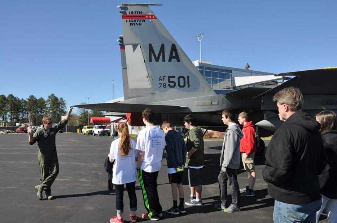 Captain Osme "Hooz" Benedict, 104th Fighter Wing Pilot, gives children from the Wright Flight program a tour of an F-15 Eagle, April 29, 2015, Barnes Air National Guard Base, Westfield, Mass. The Wright Flight program is a goal-oriented aviation program for local area middle and high school students where upon completion of the course students are given the opportunity to fly a civilian aircraft (U.S.Air National Guard photo by Senior Airman Loni Kingston/Released).
