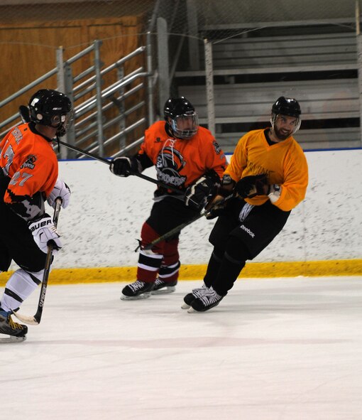 Members of the Horsham Reapers, based out of Horsham Air Guard Station, Pennsylvania, fend off a member of the Delaware Bruins hockey club during the Face off for Autism tournament, April 25, 2015, at Ice Line Quad Rinks, West Chester, Pennsylvania. The newly-formed Reapers consist of 15 members associated with both the state’s Air and Army National Guard. (U.S. Air National Guard photo by Tech. Sgt. Andria Allmond/Released)
