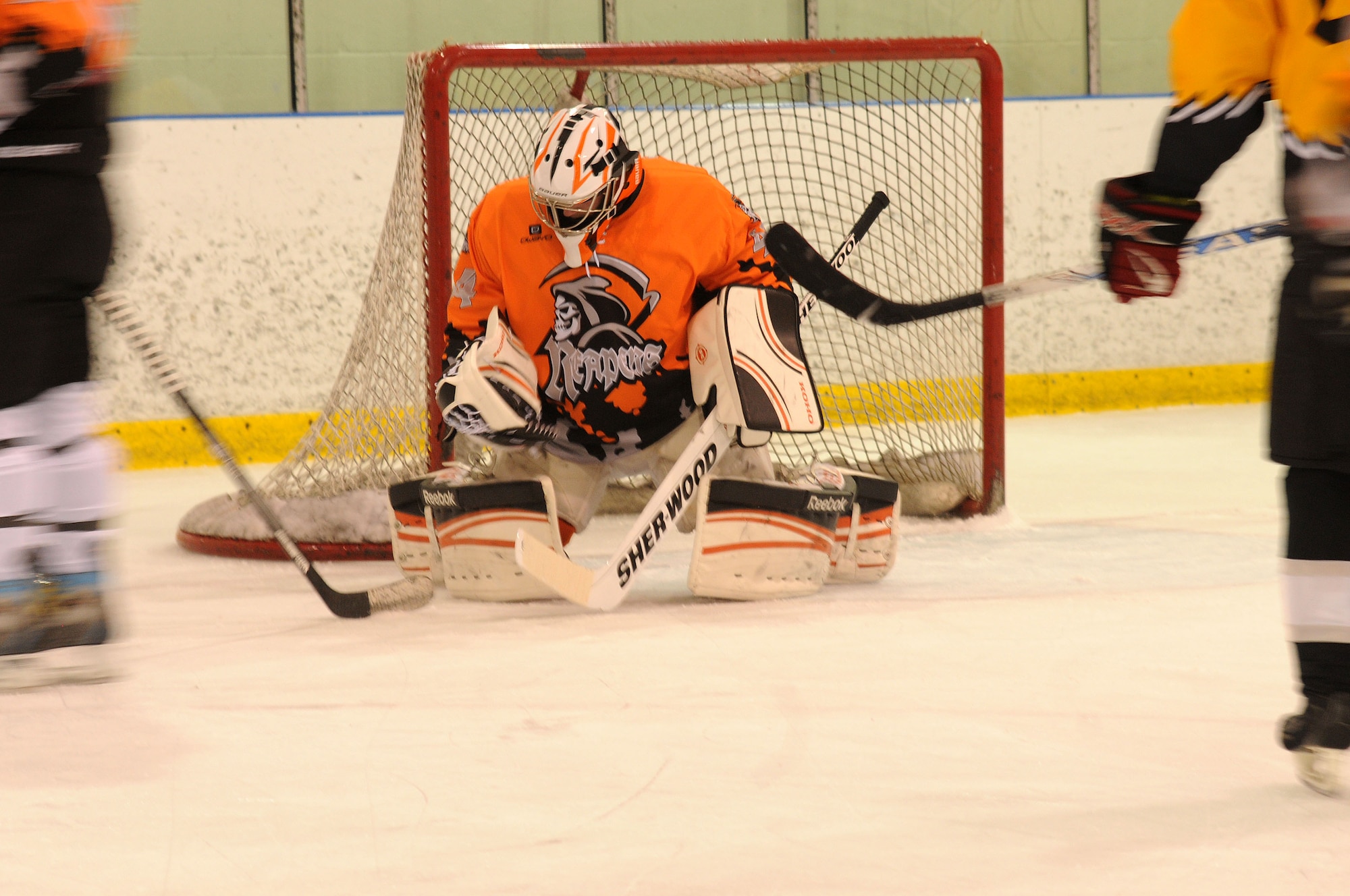 Senior Airman Jason Thomas, 111th Security Forces Squadron, Horsham Air Guard Station, Pennsylvania, is postured to make a save during the Face Off to Autism tournament at Ice Line Quad Rinks, April 25, 2015, in West Chester, Pennsylvania. Thomas formed the Guard-based hockey team, who practiced and played together for the first time during the tournament. (U.S. Air National Guard photo by Tech. Sgt. Andria J. Allmond/Released)