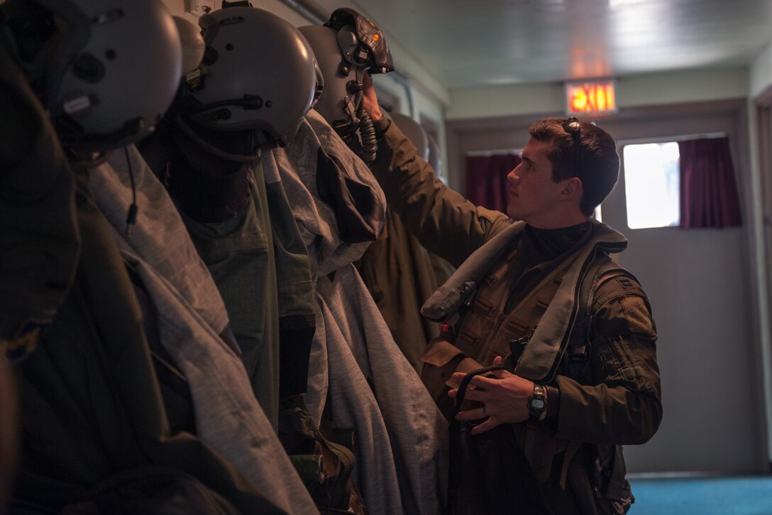 U.S. Air Force Capt. Jacob “Apollo” Allen, 35th Fighter Squadron F-16 Fighting Falcon pilot, puts on his flight equipment prior to flying during exercise Max Thunder 15-1 at Gwangju Air Base, Republic of Korea, April 21, 2015. Max Thunder is a large-scale employment exercise designed to increase interoperability between U.S. and ROK forces, and ultimately enhance commitments to maintain peace in the region. (U.S. Air Force photo by Senior Airman Taylor Curry/Released)