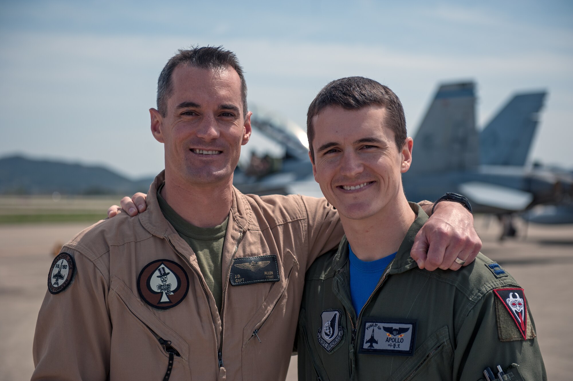 U.S. Marine Corps Capt. Jarrod “Bluto” Allen, Marine All Weather Fighter Attack Squadron 225 F/A-18 Hornet pilot, and U.S. Air Force Capt. Jacob “Apollo” Allen, 35th Fighter Squadron F-16 Fighting Falcon pilot, pose for a photo together during exercise Max Thunder 15-1 at Gwangju Air Base, Republic of Korea, April 17, 2015. (U.S. Air Force photo by Senior Airman Taylor Curry/Released)
