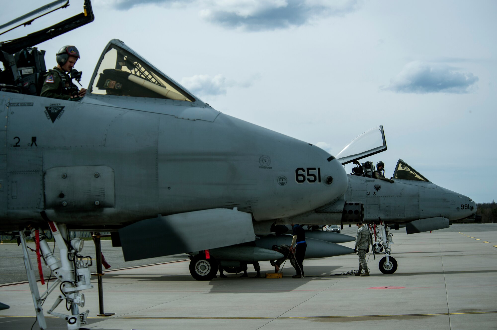U.S. Air Force A-10 Thunderbolt II attack aircraft pilots wait to climb out of their aircraft after landing at Ämari Air Base, Estonia, May 1, 2015. About 66 Airmen and support equipment from the 355th Fighter Wing at Davis-Monthan Air Force Base, Arizona, and the 52nd Fighter Wing at Spangdahlem Air Base, Germany, will support the deployment in Estonia. (U.S. Air Force photo by Senior Airman Rusty Frank/Released)