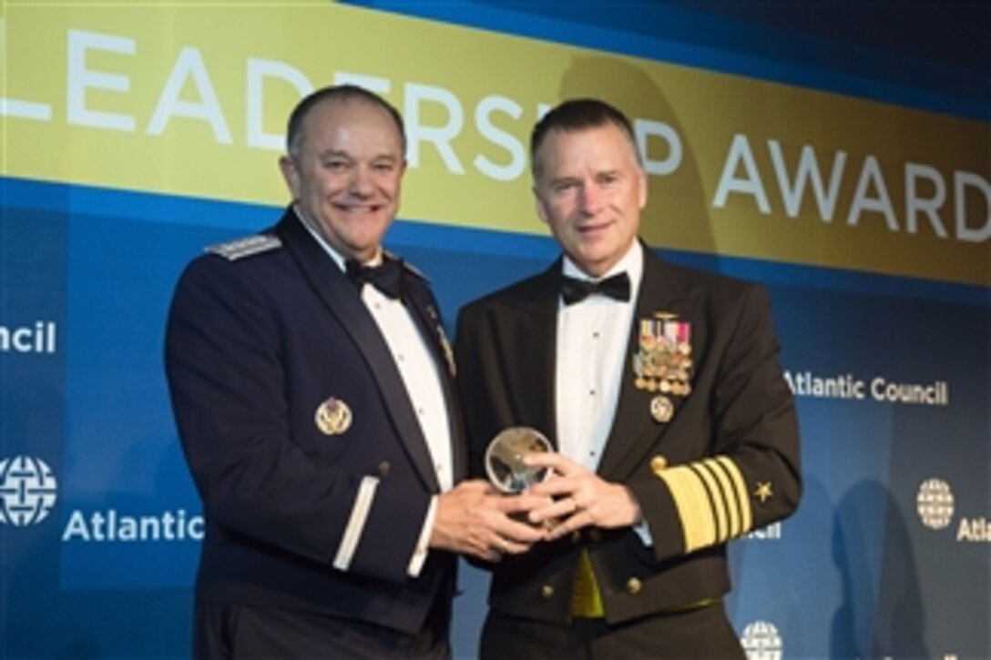 Navy Adm. James A. Winnefeld Jr., right, vice chairman of the Joint Chiefs of Staff, presents Air Force Gen. Philip M. Breedlove, Supreme Allied Commander Europe and commander of U.S. European Command, with the Atlantic Council’s Distinguished Military Leadership Award during an awards dinner in Washington, D.C., April 30, 2015. 