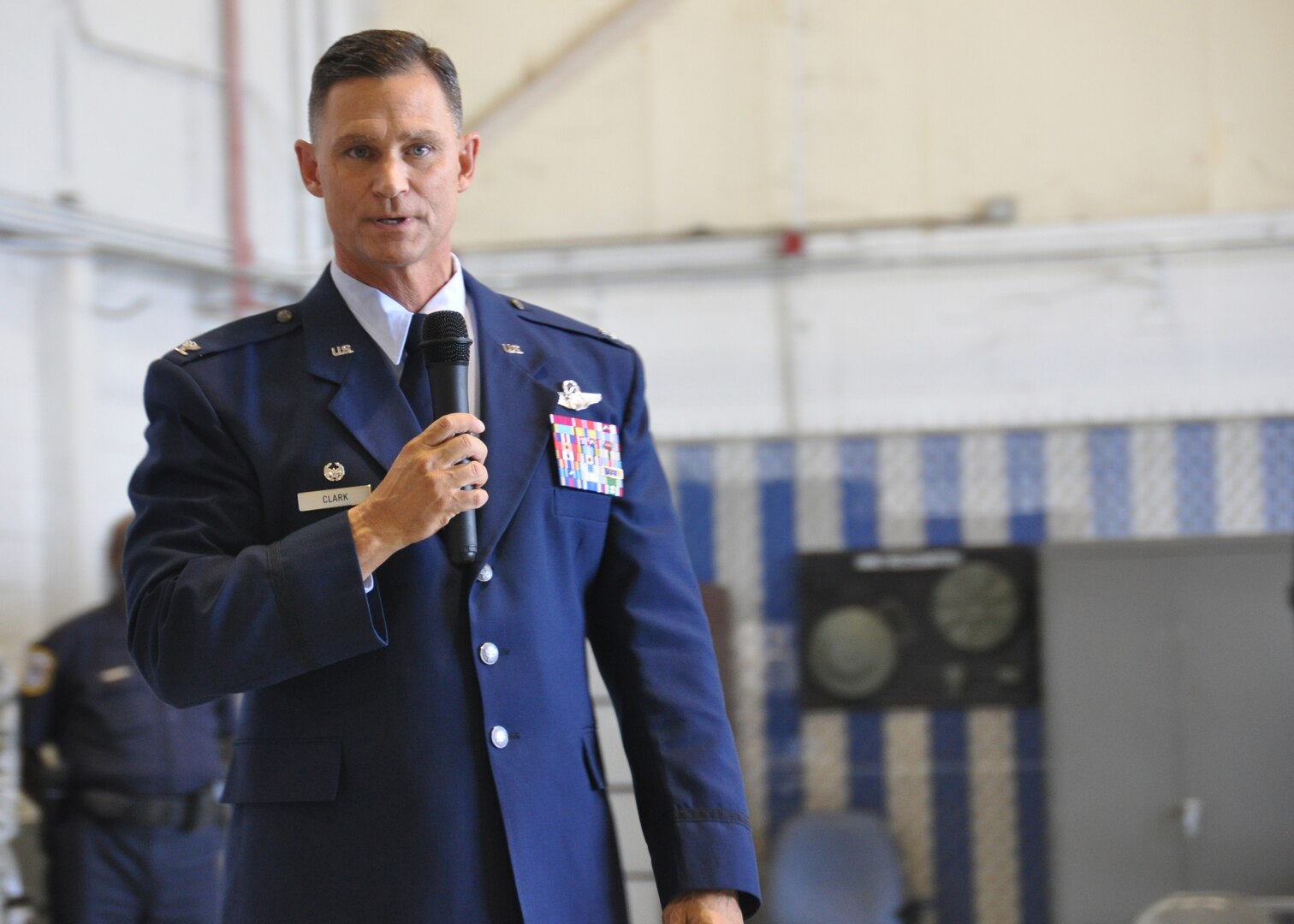 Colonel Brett Clark, 94th Airlift Wing commander, gives a briefing to the 94th AW at Dobbins Air Reserve Base, Ga, May 2. Clark was speaking at his last Commander’s Call at Dobbins, before he retires in November. (U.S. Air Force photo/ Senior Airman Miles Wilson)