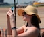 A woman takes a photo as she watches the U.S. Navy Flight Demonstration Team Blue Angels F/A-18 Hornets perform during the 2015 Defenders of Liberty Airshow at Barksdale Air Force Base, Louisiana, May 2. The air show, which drew an estimated 60,000 people per day, featured attractions such as the Blue Angels, the U.S. Army Parachute Team “Golden Knights,