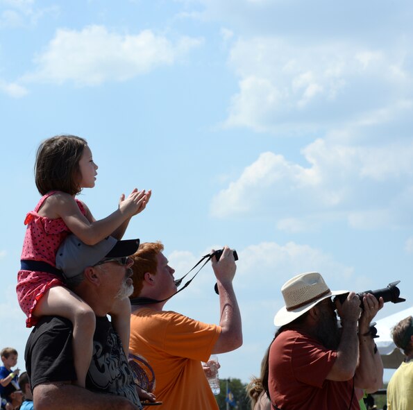 Spectators watch the U.S. Navy Flight Demonstration Team Blue Angels F/A-18 Hornets perform during the 2015 Defenders of Liberty Airshow at Barksdale Air Force Base, Louisiana, May 2. The mission of the Blue Angels is to showcase the pride and professionalism of the United States Navy and Marine Corps by inspiring a culture of excellence and service to country through flight demonstrations and community outreach. (U.S. Air Force photo/Airman 1st Class Curt Beach)