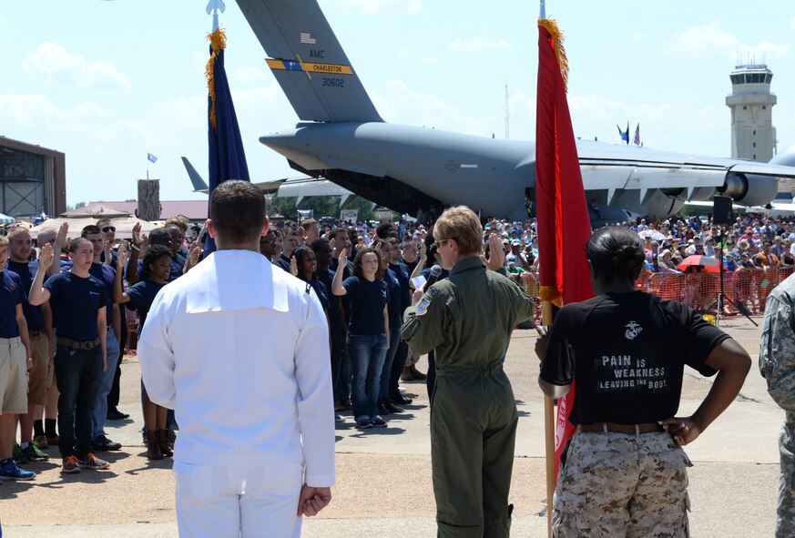 Col. Kristin Goodwin, 2nd Bomb Wing commander, administers the Oath of Enlistment to Armed Forces recruits to the United States military during the 2015 Defenders of Liberty Airshow at Barksdale Air Force Base, Louisiana, May 2. The recruits swore the oath to defend their country by serving in the Army, Air Force, Navy, Marine Corps and Coast Guard. (U.S. Air Force photo/Airman 1st Class Curt Beach)