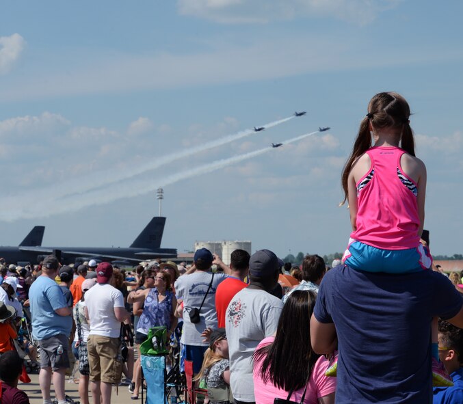 Spectators watch the U.S. Navy Flight Demonstration Team Blue Angels F/A-18 Hornets fly by during the 2015 Defenders of Liberty Airshow at Barksdale Air Force Base, Louisiana, May 2. The mission of the Blue Angels is to showcase the pride and professionalism of the United States Navy and Marine Corps by inspiring a culture of excellence and service to country through flight demonstrations and community outreach. (U.S. Air Force photo/Airman 1st Class Curt Beach)