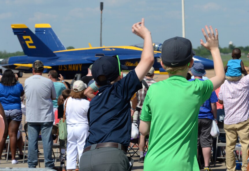 Children wave as a U.S. Navy Flight Demonstration Team Blue Angels F/A-18 Hornet prepares to take off during the 2015 Defenders of Liberty Airshow at Barksdale Air Force Base, Louisiana, May 2. The mission of the Blue Angels is to showcase the pride and professionalism of the United States Navy and Marine Corps by inspiring a culture of excellence and service to country through flight demonstrations and community outreach. (U.S. Air Force photo/Airman 1st Class Curt Beach)