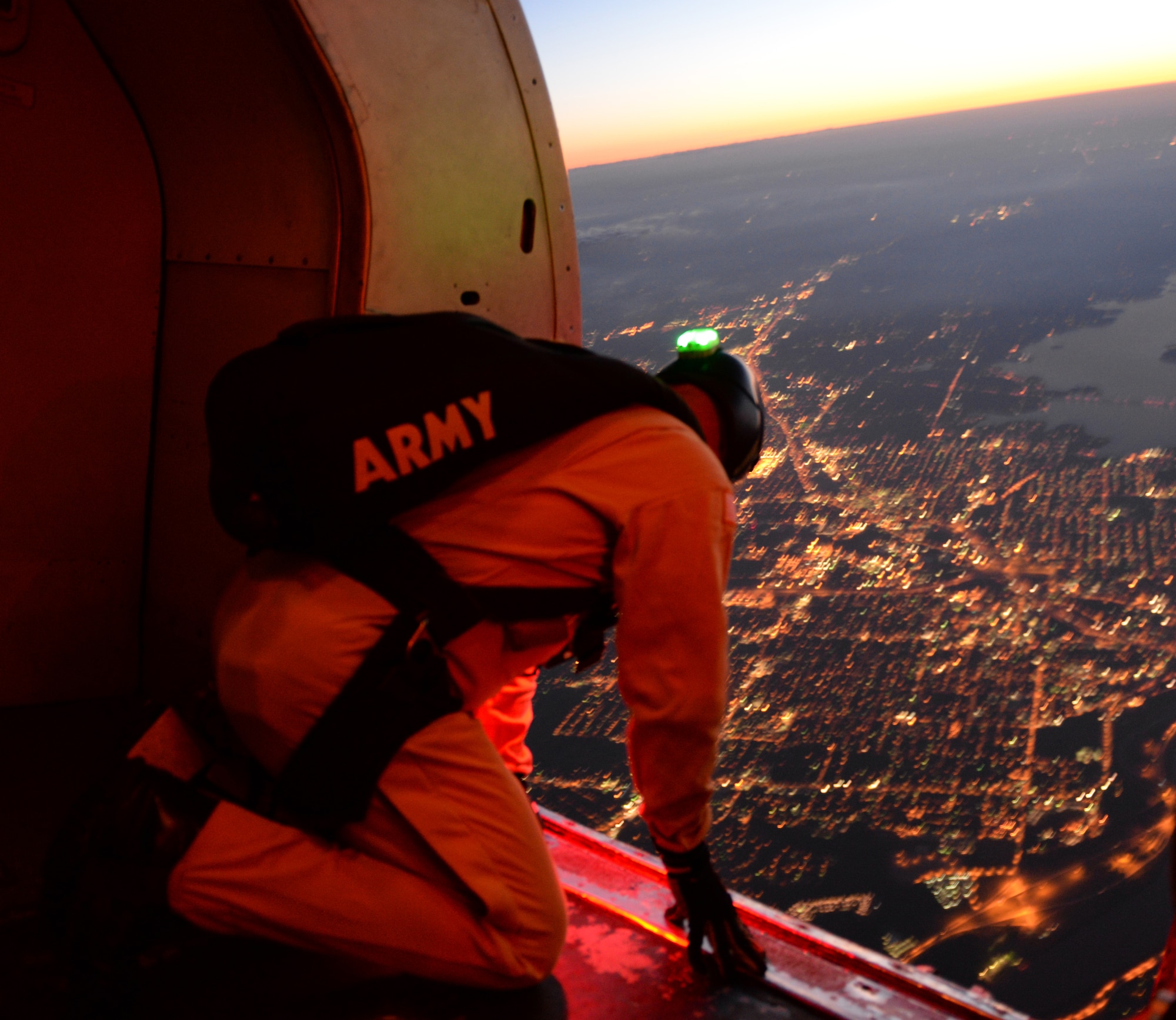 Sgt. Mike Koch, U.S. Army Parachute Team "Golden Knights" airborne communications specialist, surveys the sky from the tail of a C-31A Troopship above Barksdale Air Force Base, Louisiana, May 1, 2015. Koch, a Wisconsin native, began jumping in 2009, and has since logged more than 740 free fall parachute jumps and 28 Military Static Line Jumps. The Golden Knights, stationed at Fort Bragg, North Carolina, flew to Barksdale to take part in the Defenders of Liberty Airshow. (U.S. Air Force photo/Airman 1st Class Curt Beach)