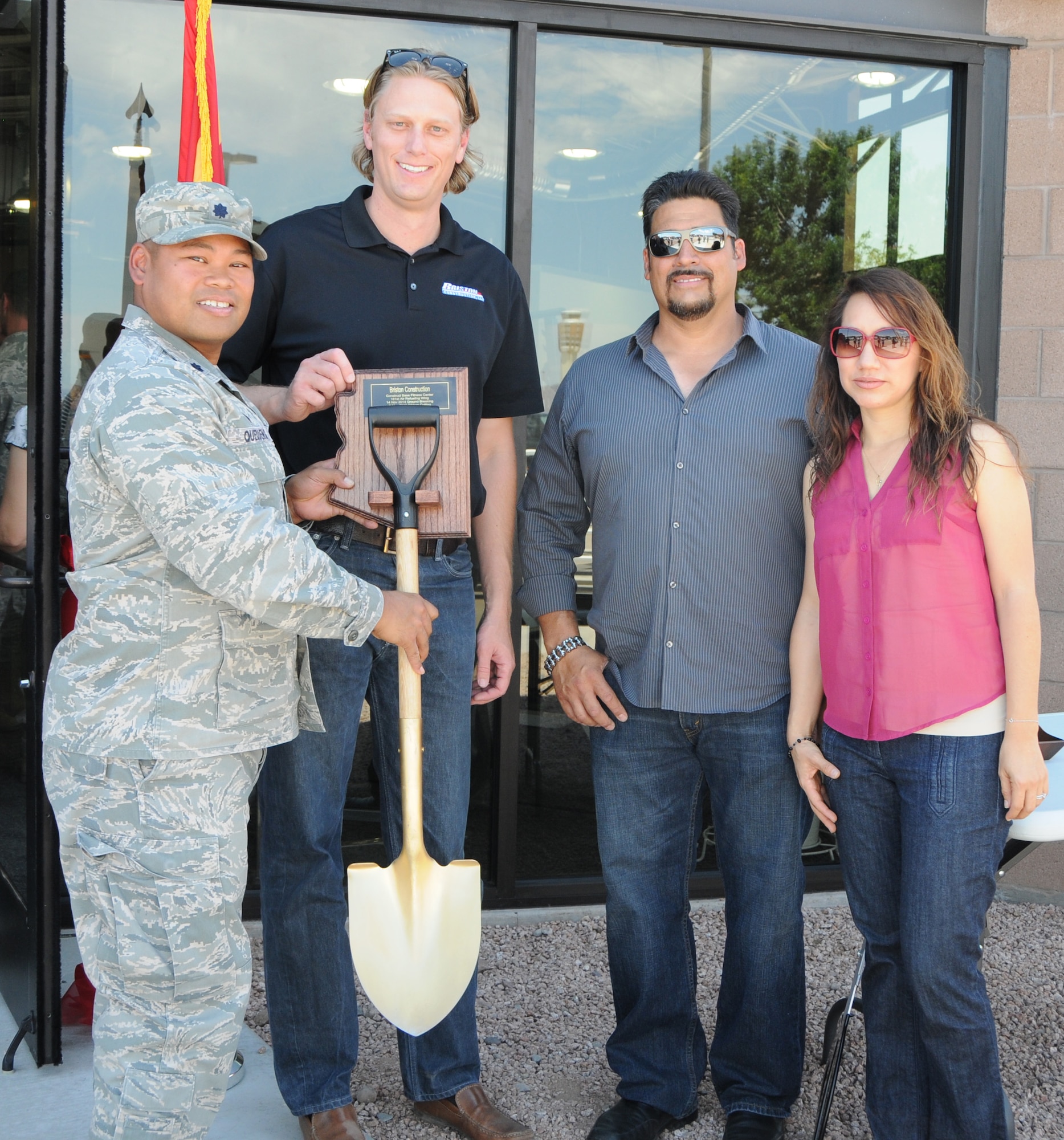 Lt. Col. Eric Queddeng, 161st Civil Engineer Squadron commander, presents a plaque to Brandon Carr, Jerome Padgett, and Gabby Zendejas of the contracted construction crew at the ribbon cutting ceremony for the wing’s new stand-alone fitness center at the Phoenix Air National Guard base, May 2. At 2,400 square-feet, the first ever stand-alone fitness center to be built on an Air National Guard base after the base’s original construction will accommodate nearly twice as many Airmen as the old facility. (U.S. Air National Guard photo by Tech. Sgt. Courtney Enos)