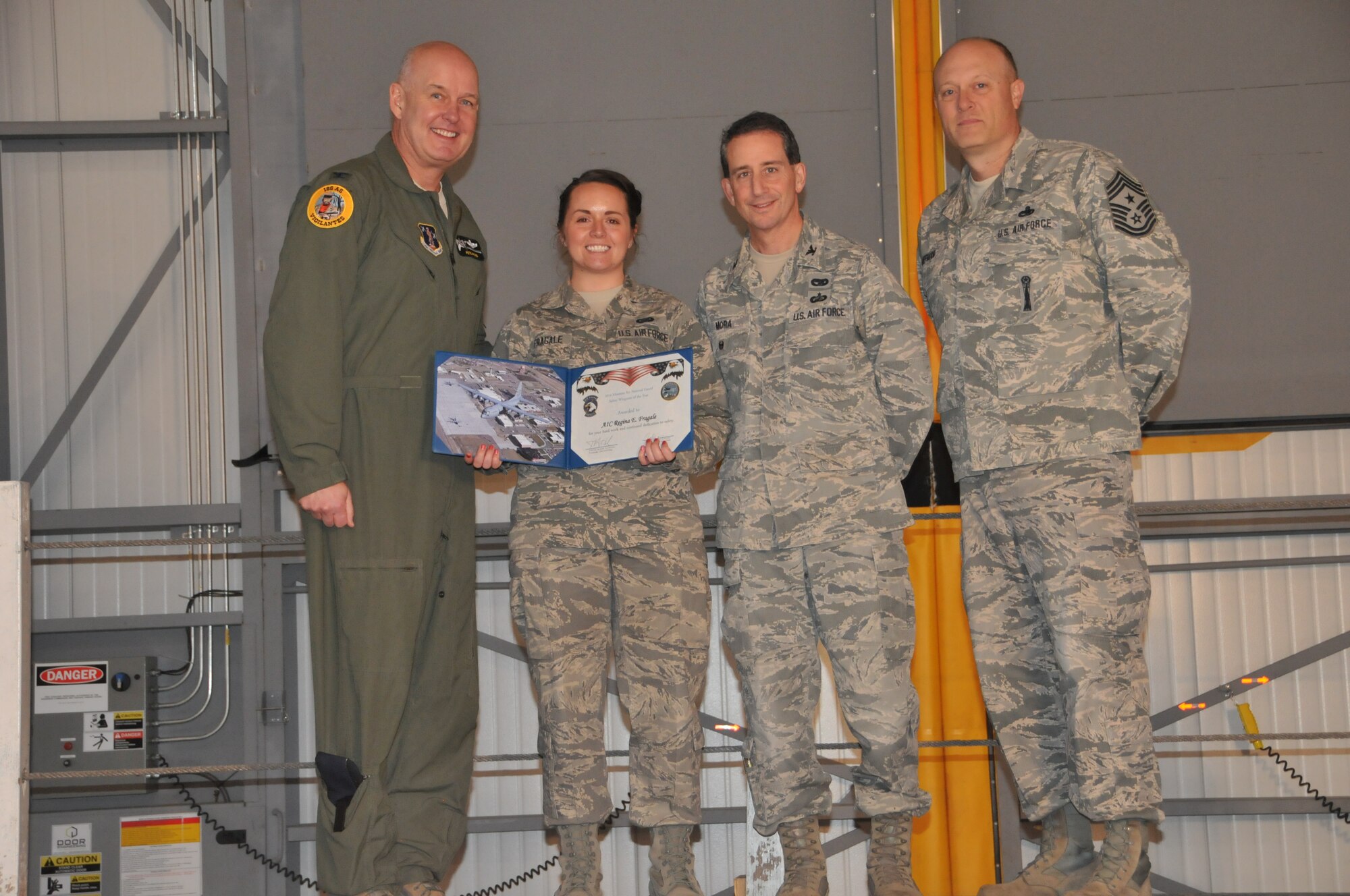 120th Operations Group Senior Airman Regina Fragale accepts her award as Safety Wingman of the Year after putting her Self-Aid Buddy care skills to use during C-130 Hercules in-flight emergency in the summer of 2014. (Montana Air National Guard photo/Staff Sgt. Lindsey Soulsby)