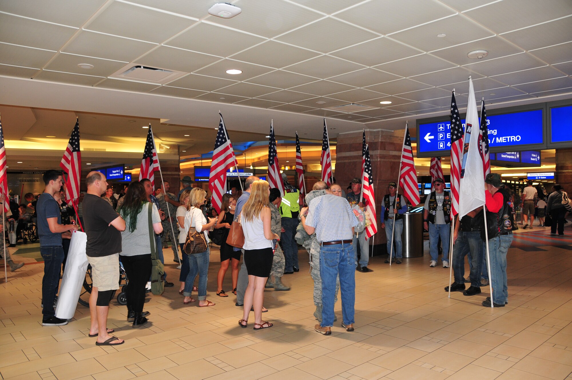Airman 1st Class Madison Green is welcomed home by her family and the Freedom Riders at Phoenix Sky Harbor International Airport, May 2, 2015.  Seventeen members from the 161st Security Forces Squadron returned home after spending six months deployed to Southwest Asia.  (U. S. Air National Guard photo by Master Sgt. Kelly M. Deitloff)