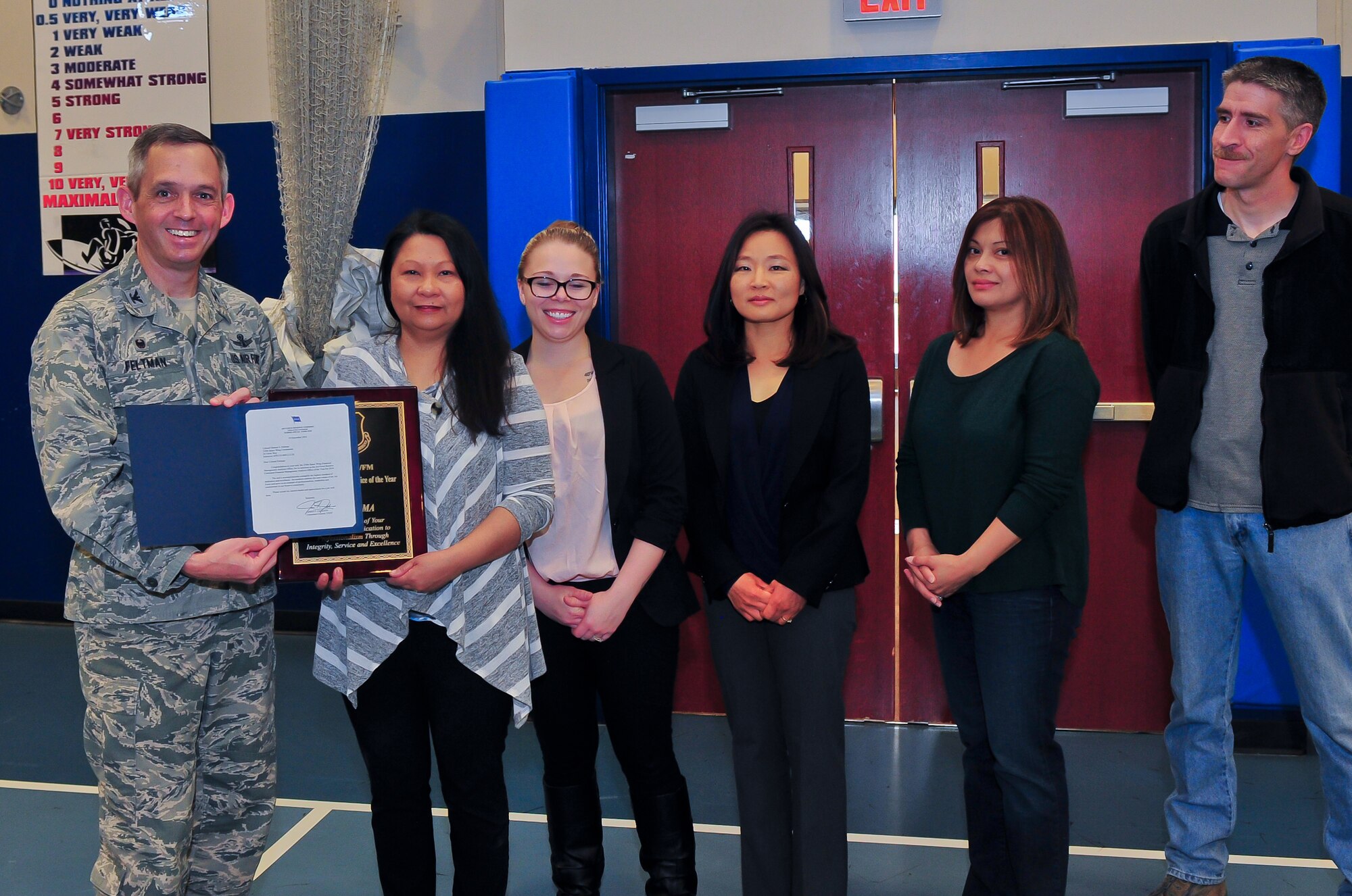 Air Force Reserve Col. Damon S. Feltman, 310th Space Wing Commander, presents an award to the 310th SW Financial Management Office during a commander's call May 2, 2015, at Schriever Air Force Base, Colo. The 310th FM was the financial analysis office of the year for fiscal year 2014.
(U.S. Air Force photo/Tech. Sgt. Nicholas B. Ontiveros)
