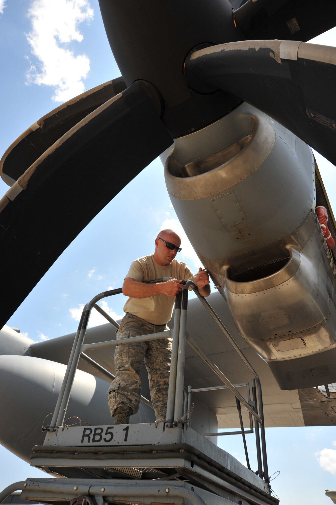 Tech. Sgt. Ronnie Graham, 403rd Maintenance Squadron jet engine craftsman, removes the panel from a  WC-130J engine in preparation for a “man on the stand” check May 1, 2015. Mechanics have to check for bleed air leaks while the engine is running to locate the oil leak. (U.S. Air Force photo/Maj. Marnee A.C. Losurdo)