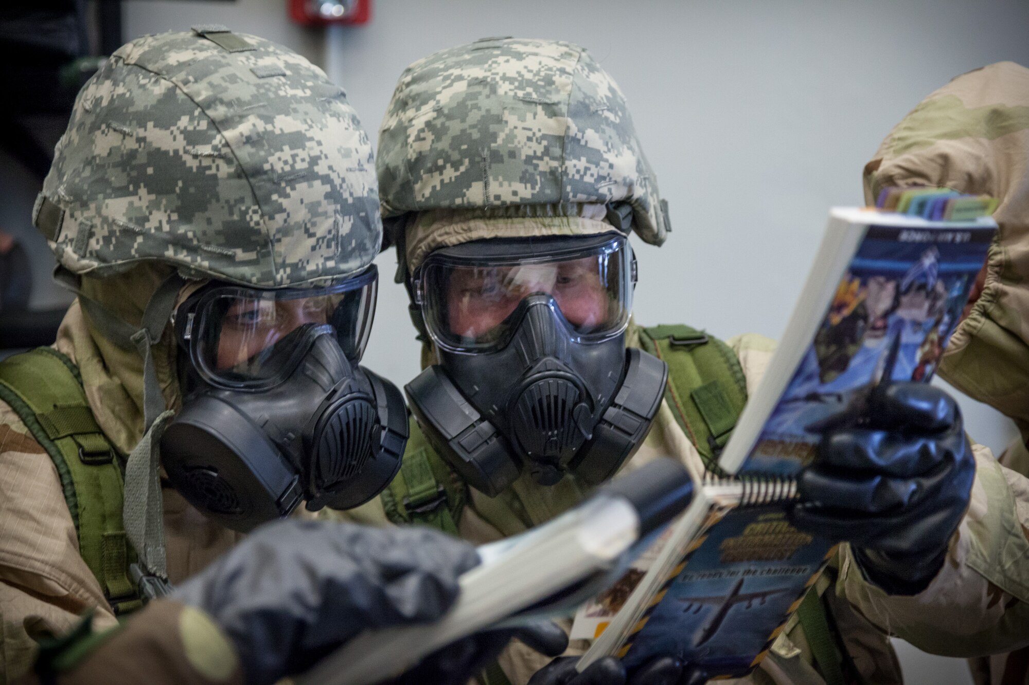 Maj. Julie Sherman (left) and Senior Airman Brandon Trauba (right), 934th Aeromedical Evacuation Squadron, look through their Airman's Manual for answers during a Chemical, Biological, Radiological, Nuclear, and Explosives (CBRNE) challenge.  Members of the 934 AES brushed up on skills and competed in challenges during a block training session April 30 and May 1 at the Minneapolis-St. Paul Air Reserve Station, Minn.  (U.S. Air Force photo by Shannon McKay/Released)