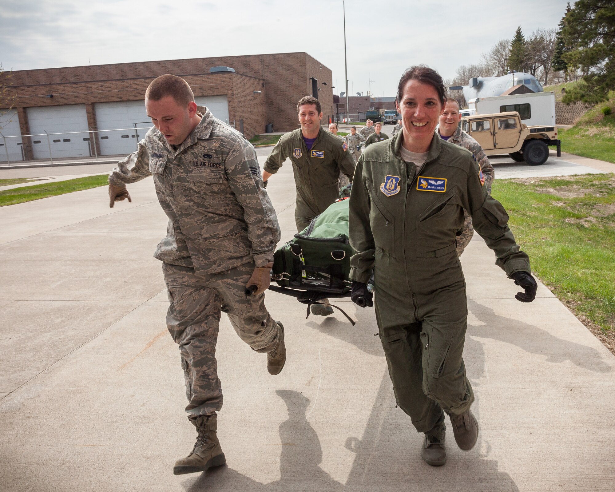 (From left) Senior Airmen Brandon Hannam and Brian Tremain, Capt. Deanna Jensen, and 2nd Lt. Jon Polos, 934th Aeromedical Evacuation Squadron, run with the last litter in their group to finish an obstacle course challenge.  Members of the 934 AES brushed up on skills and competed in challenges during a block training session April 30 and May 1 at the Minneapolis-St. Paul Air Reserve Station, Minn.  (U.S. Air Force photo by Shannon McKay/Released)