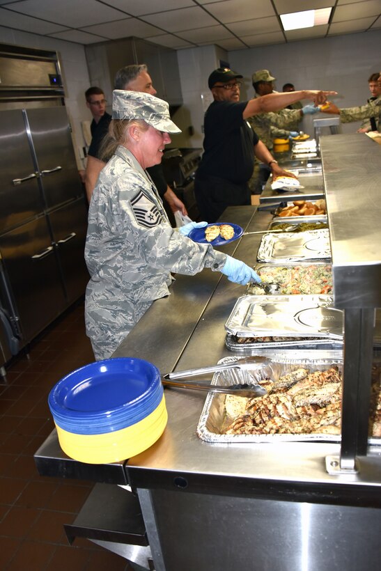 Maryland Air National Guardsmen serve dinner at Warfield Air National Guard Base in Baltimore May 1. The Airmen are supporting Operation Baltimore Rally during the state of emergency in Baltimore. (U.S. Air National Guard photo by Senior Master Sgt. Ed Bard/RELEASED)