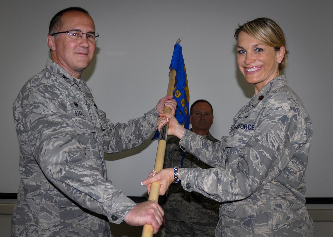 Maj. Pamela Wilson accepts the 919th Special Operations Communications Squadron guidon from Col. Brian Stahl, the 919th Special Operations Mission Support Group commander, during her assumption of command ceremony May 3 at Duke Field.  (U.S. Air Force photo/Dan Neely)