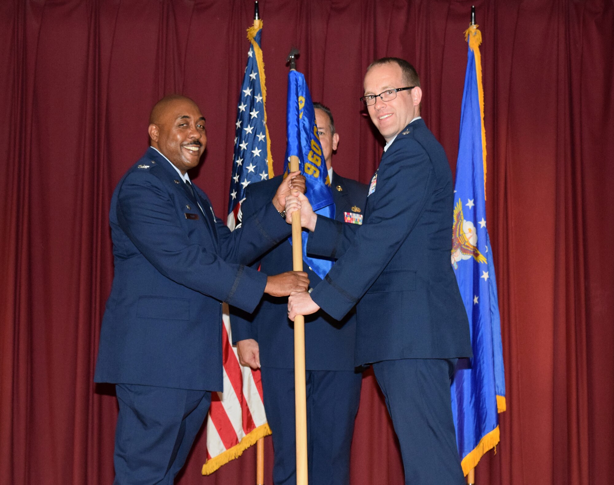 Col. Lloyd I. Terry Jr., 960th Cyberspace Operations Group commander, presents the 426th Network Warfare Squadron guidon to Lt. Col. Neil Schroeder, 426th NWS commander, during the squadron change of command ceremony May 2, 2015 at Carter Hall on Joint Base San Antonio-Lackland, Texas. Schroeder comes to the 426th NWS from Offutt Air Force Base, Nebraska, where he served as a Cyberspace Capabilities staff officer for the U.S. Strategic Command Capability and Resource Integration Directorate. (U.S. Air Force photo/Tech. Sgt. Lindsey Maurice)