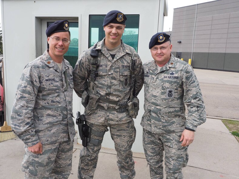 Maj. Leo Moreno (left) and Maj. Greg Peterson, 934th Security Forces Squadron, congratulate Staff Sgt. Brian Hansen after pinning on ceremonial 2nd Lt. bars. Hanson learned today he had been selected for Officer Training School where he will earn an active duty commission. (photo by Paul Zadach)