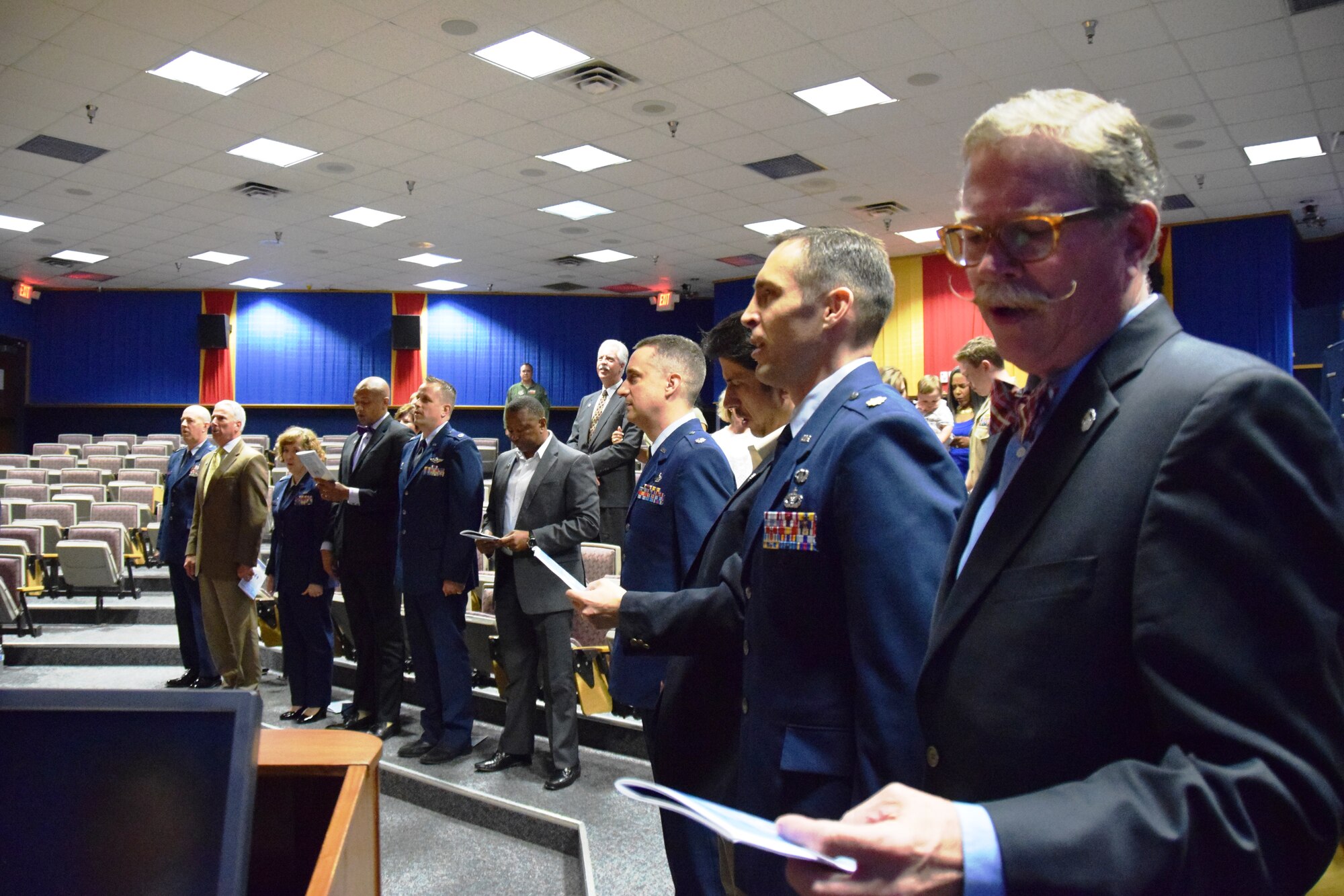 Honorary Commander’s and those in attendance sing the Air Force song at the conclusion of the 433rd Airlift Wing’s Honorary Commanders Induction Ceremony, May 2, 2015 at Joint Base San Antonio-Lackland, Texas.  Five new honorary commanders were inducted at the ceremony in lieu of the previous ceremony held on March, 7, 2015. (U.S. Air Force Photo by Tech. Sgt. Carlos J. Trevino)

