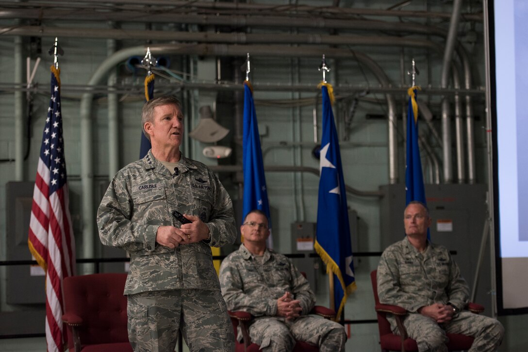 U.S. Air Force Gen. Hebert J. “Hawk” Carlisle, commander of Air Combat Command, speaks to Airmen during an “all call” as Maj. Gen. Steven Cray, adjutant general, Vermont National Guard, and Col. Patrick Guinee, commander, 158th Fighter Wing, listen at Burlington International Airport, South Burlington, Vt., April 11, 2015. Visiting his first Air National Guard base as the COMACC, Carlisle met with leadership, had lunch with Airmen and recognized outstanding performers. (U.S. Air National Guard photo by Tech. Sgt. Sarah Mattison)