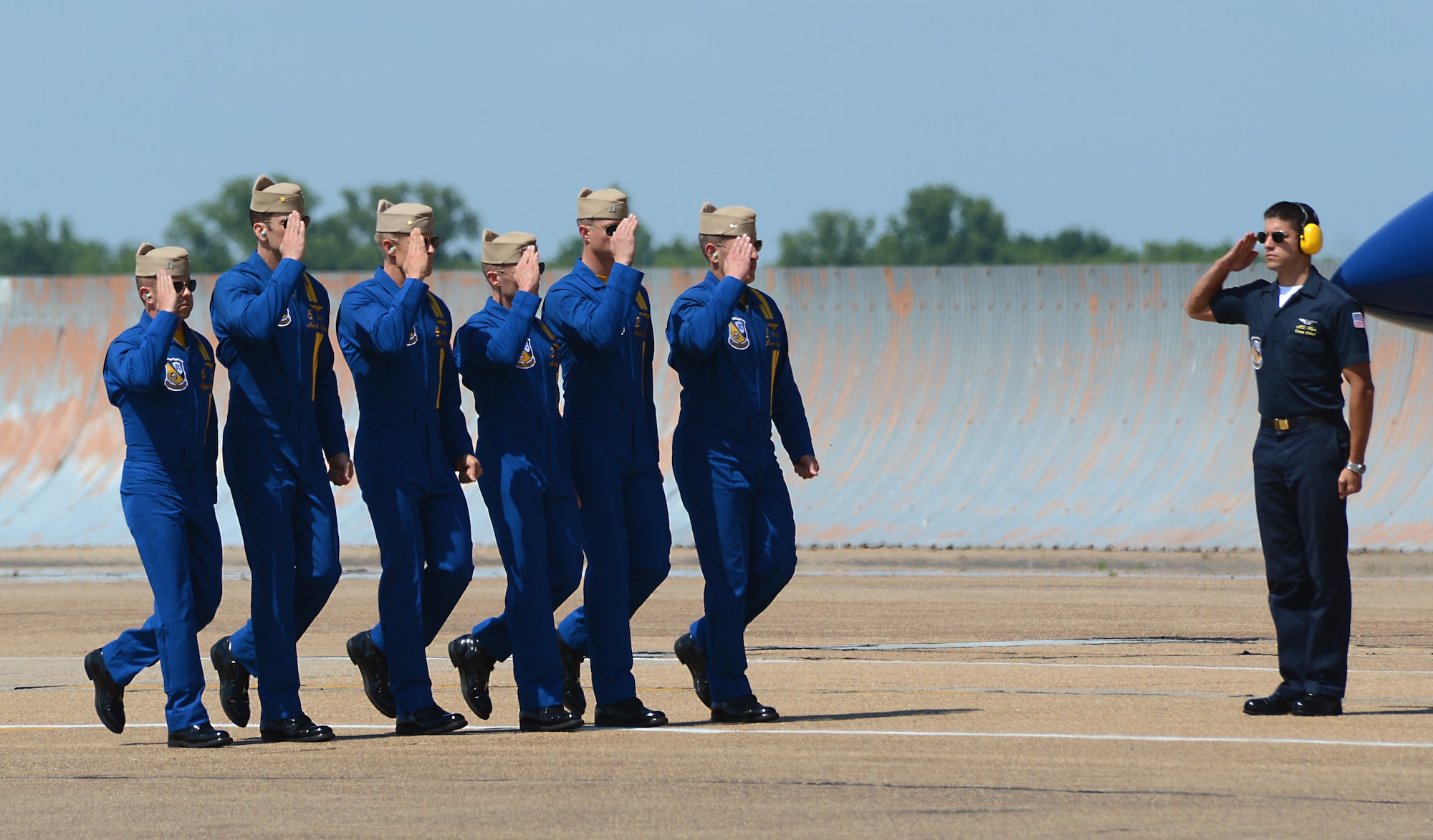 Aviation Electrician Second Class Steven Hart, U.S. Navy Flight Demonstration Team Blue Angels crew chief, salutes the F/A-18 aircrew during the 2015 Defenders of Liberty Air Show at Barksdale Air Force Base, Louisiana, May 2. To be a demonstration pilot, applicants must be career-oriented, carrier-qualified, active-duty Navy or Marine Corps tactical jet pilot with a minimum of 1,250 flight hours. (U.S. Air Force photo/Senior Airman Benjamin Gonsier)
