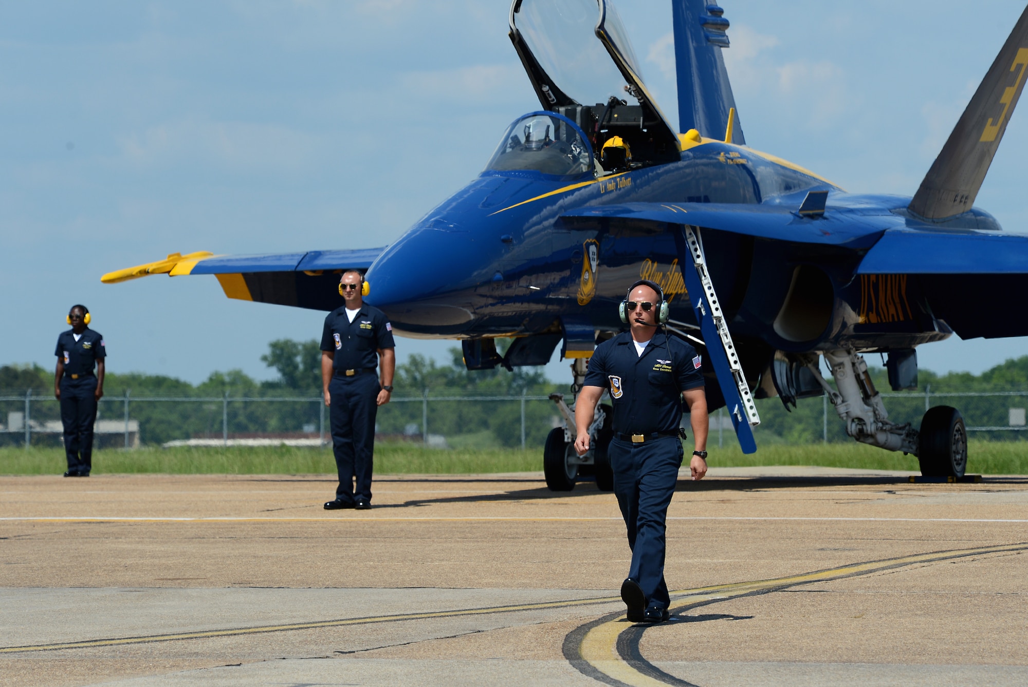 Aviation Ordnanceman First Class Zachery Bernat, U.S. Navy Flight Demonstration Team Blue Angels crew coordinator, marches away from F/A-18 Hornets during the 2015 Defenders of Liberty Air Show at Barksdale Air Force Base, Louisiana, May 2. The Blue Angels are representatives of the excellence and professionalism found throughout the fleet. Each Blue Angel team member is an ambassador and representative of their fleet counterparts. Bernat is a native of Punxsutawney, Pennsylvania. (U.S. Air Force photo/Senior Airman Benjamin Gonsier)
