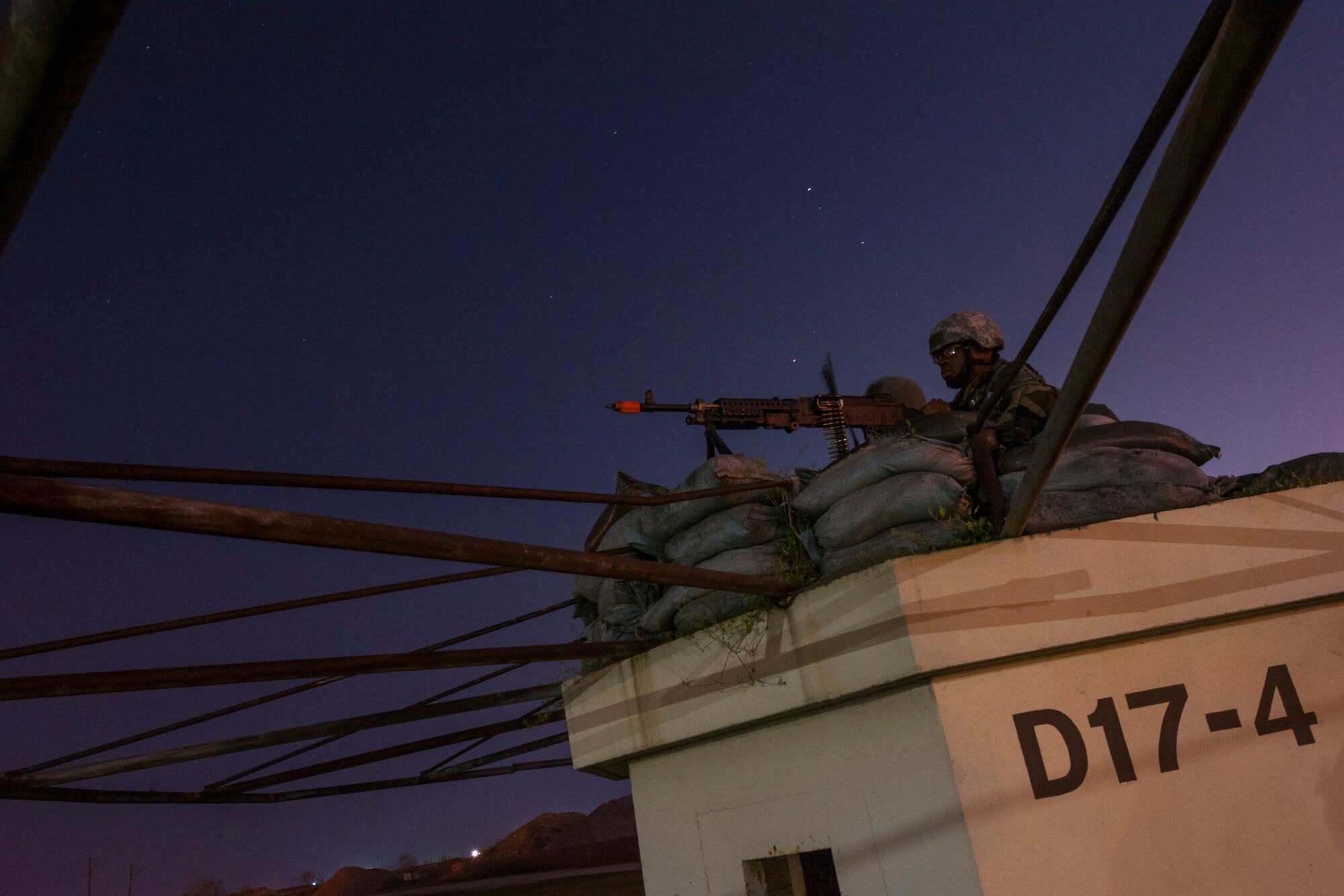 An 8th Security Forces Squadron defender keeps guard at a defensive fighting position during Exercise Beverly Midnight 15-3 at Kunsan Air Base, Republic of Korea, May 1, 2015. During the six-day exercise, wing inspection team members evaluated Wolf Pack Airmen in a controlled environment to inspect their ability to adapt and perform in wartime scenarios. (U.S. Air Force photo by Senior Airman Taylor Curry/Released)