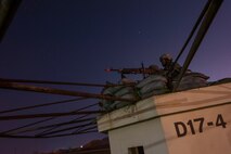 An 8th Security Forces Squadron defender keeps guard at a defensive fighting position during Exercise Beverly Midnight 15-3 at Kunsan Air Base, Republic of Korea, May 1, 2015. During the six-day exercise, wing inspection team members evaluated Wolf Pack Airmen in a controlled environment to inspect their ability to adapt and perform in wartime scenarios. (U.S. Air Force photo by Senior Airman Taylor Curry/Released)