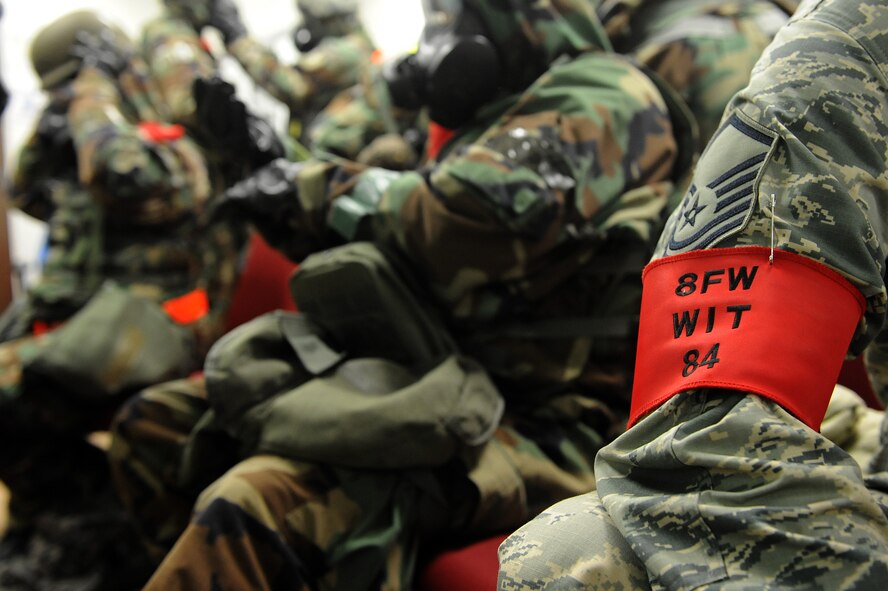 The wing inspection team gets into mission-oriented protective posture four during Exercise Beverly Midnight 15-3, April 29, 2015, at Kunsan Air Base, Republic of Korea.  During the six-day exercise, WIT members evaluated Wolf Pack Airmen in a controlled environment to inspect their ability to adapt and perform in wartime scenarios. (U.S. Air Force photo by Senior Airman Divine Cox/Released)