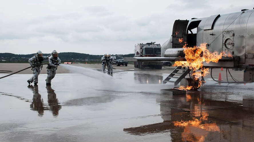 Airmen from the 8th Civil Engineer Squadron Fire Department extinguish a simulated aircraft fire during Exercise Beverly Midnight 15-3, April 29, 2015, at Kunsan Air Base, Republic of Korea. The simulated aircraft crash not only provided additional training for the 8th CES, but also tested emergency responders’ ability to respond to wartime scenarios whilst being evaluated by the wing inspection team. (U.S. Air Force photo by Senior Airman Katrina Heikkinen/Released) 