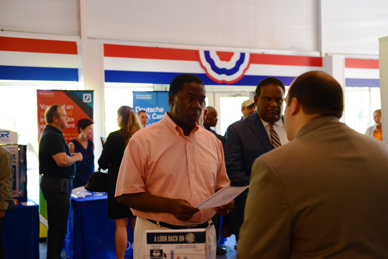 Jacksonville Mayor Alvin Brown, center, talks to a representative from the Florida Department of Financial Services during a military job fair in Ponte Vedra Beach, Florida, May 2, 2015. The job fair is sponsored by the city, the PGA Tour’s The Players Championship and the Jacksonville Military Veterans Coalition. DoD photo by Army Sgt. 1st Class Tyrone C. Marshall Jr.