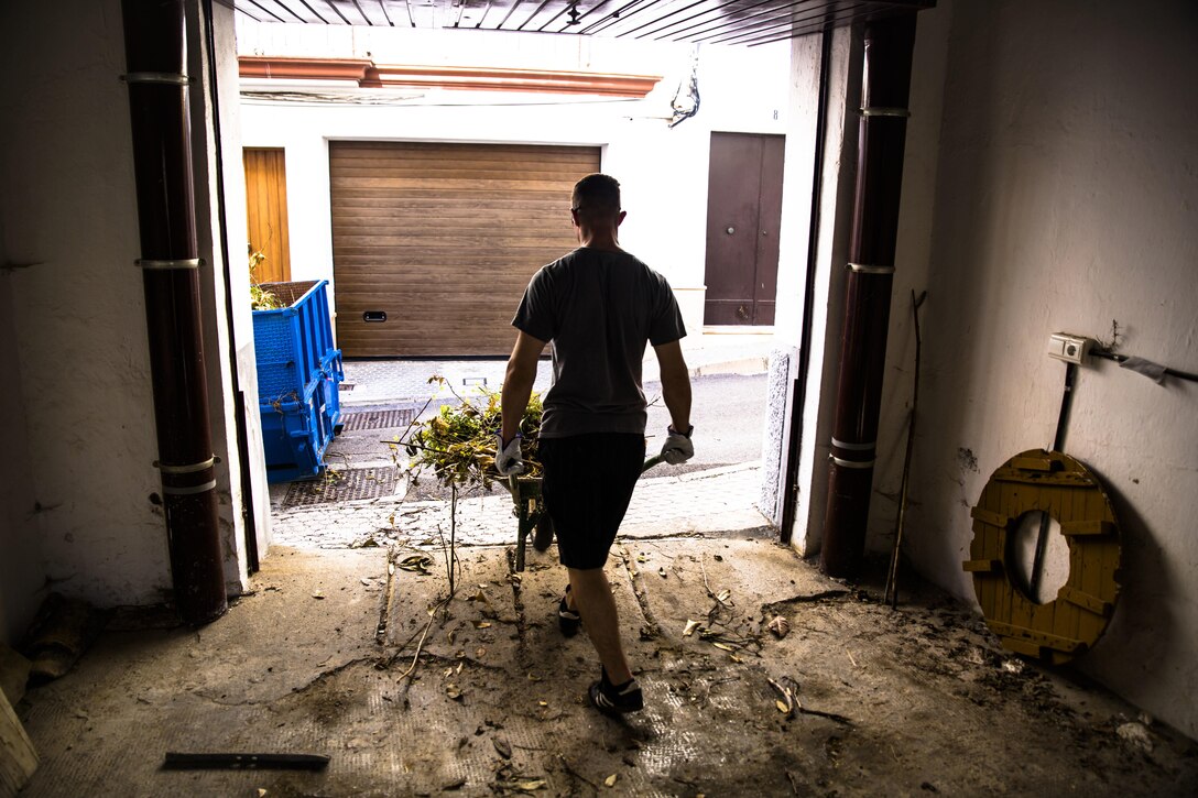 A U.S. Marine with Special-Purpose Marine Air-Ground Task Force Crisis Response-Africa removes brush with a wheelbarrow at the Santa Clara convent in Morón, Spain, April 23, 2015. Volunteers from the unit visited the convent and completed a series of restoration projects as a way to give back to the community near their base. (U.S. Marine Corps photo by Sgt. Paul Peterson/Released)