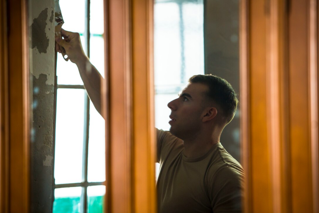 U.S. Marine Cpl. George Mason, a flight equipment technician with Special-Purpose Marine Air-Ground Task Force Crisis Response-Africa, paints a wall at the Santa Clara convent in Morón, Spain, April 23, 2015. Marines with SPMAGTF-CR-AF visited the convent as a way to give back to the community in Morón, where they are stationed as a rotational crisis-response force. (U.S. Marine Corps photo by Sgt. Paul Peterson/Released)