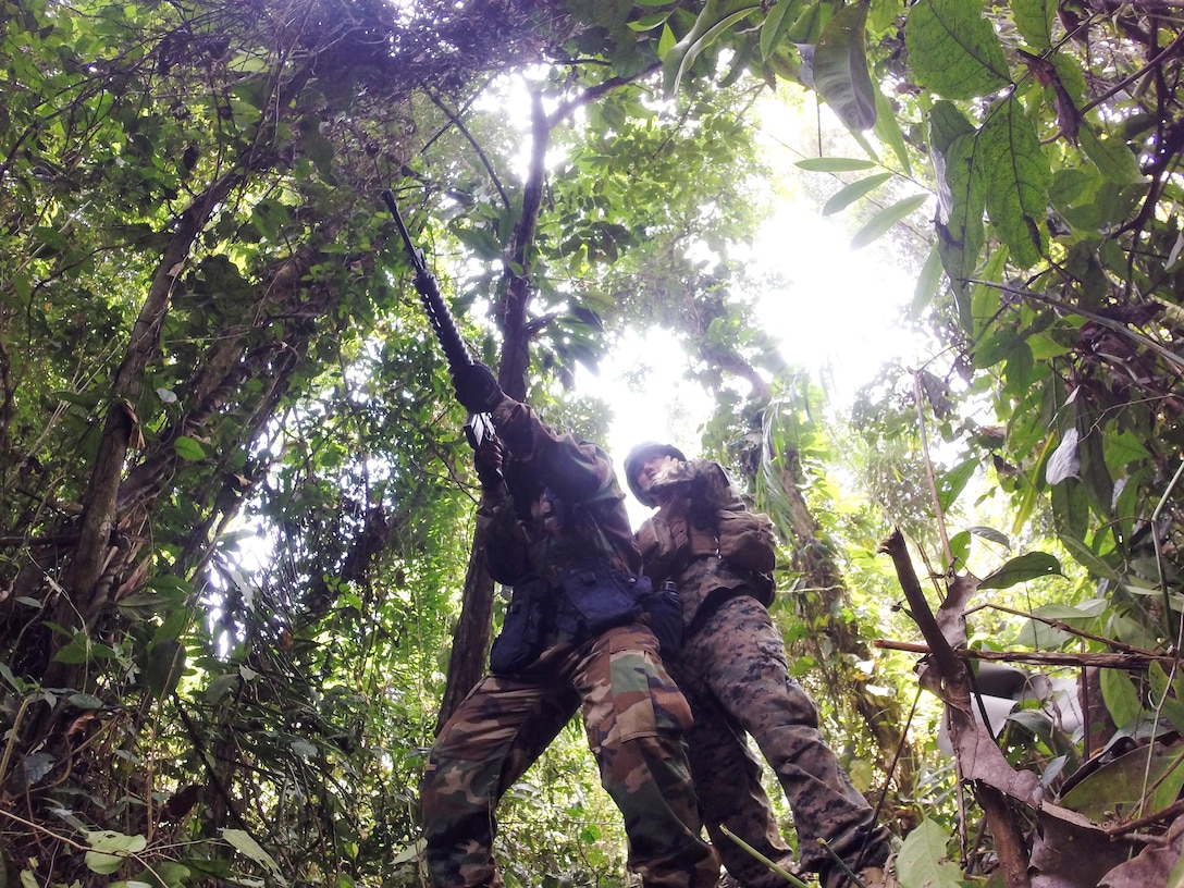 A U.S. Marine adjusts the shooting stance of a Sailor from Ghana’s Rapid Reaction Force during marksmanship training at the Jungle Warfare School, Ghana, Feb. 12, 2015. U.S. Marines from Special-Purpose Marine Air-Ground Task Force Crisis Response-Africa participated in a three-month-long maritime security exercise, Africa Partnership Station, in Ghana, Angola, Cameroon and Gabon, alongside Spanish and British Royal Marines. (Courtesy photo/Released)
